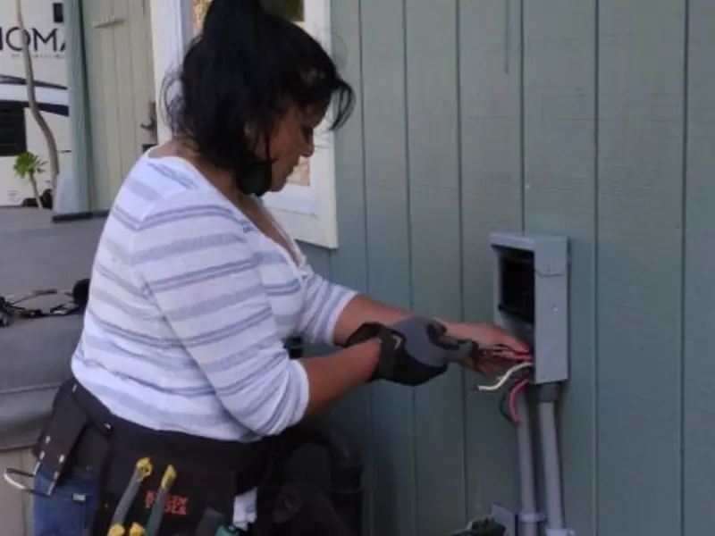 Licensed electrician wiring an exterior subpanel in Underhill